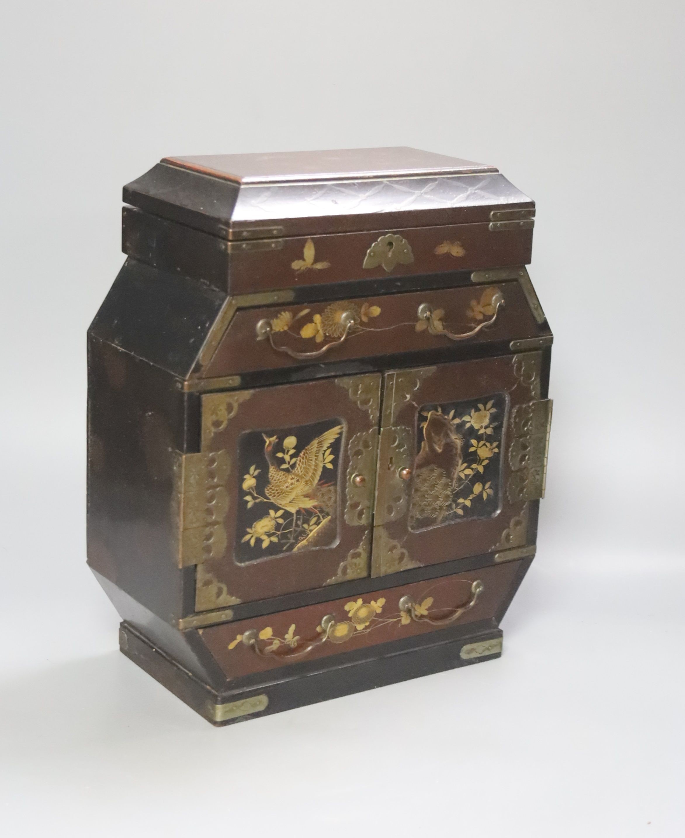 A Japanese lacquered brass bound table top cabinet, height 28cm